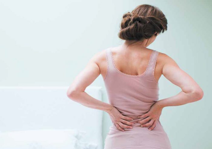 Woman rubbing aching back